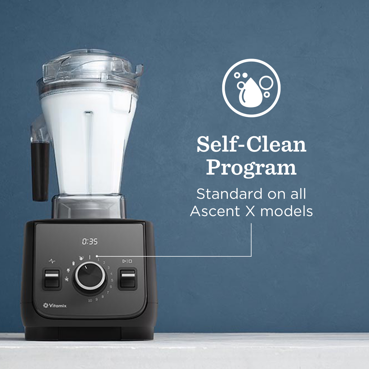 Black Vitamix blender with self-clean program text on a blue background